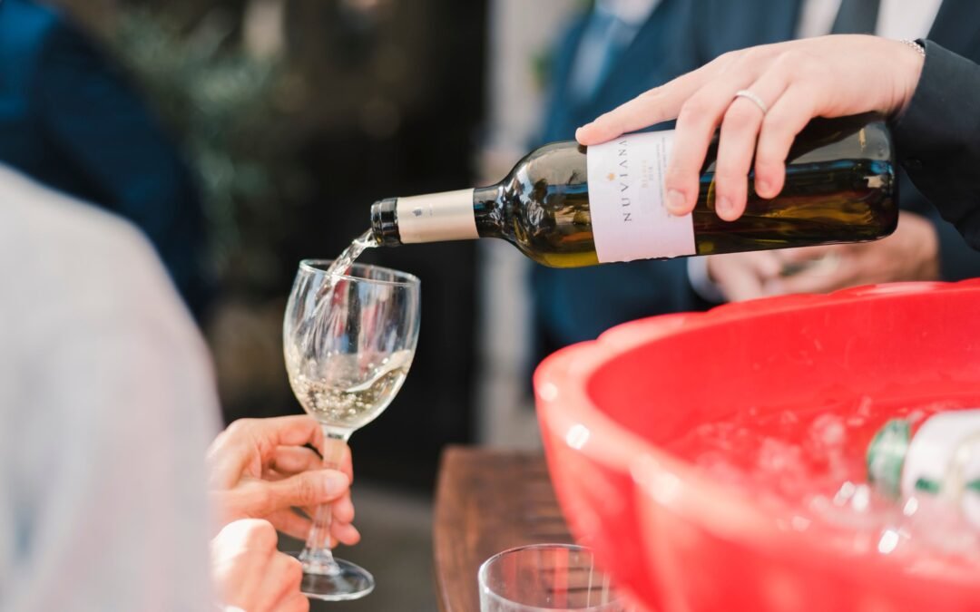 Glass of wine poured for wedding guests during cocktail hour
