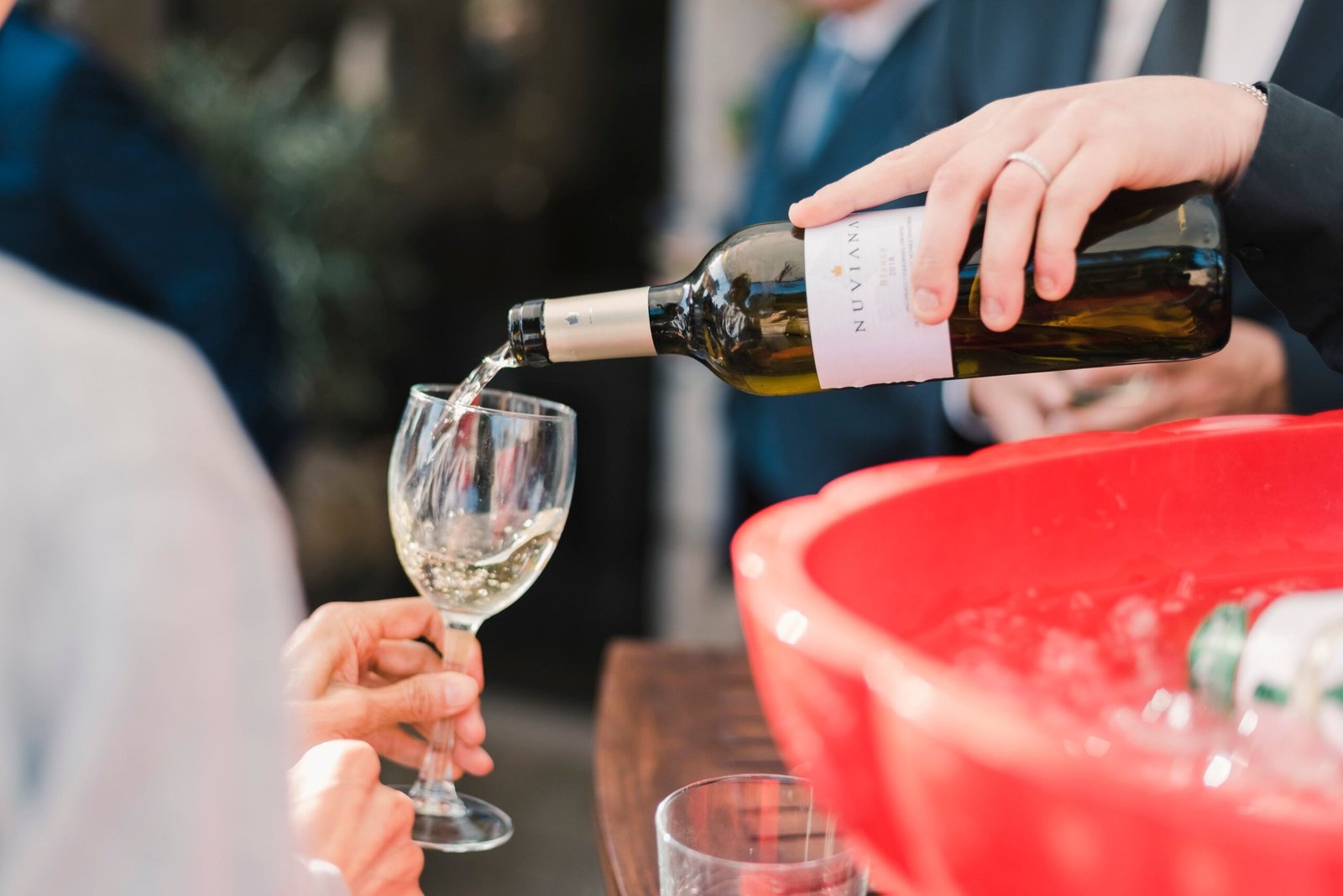 Glass of wine poured for wedding guests during cocktail hour